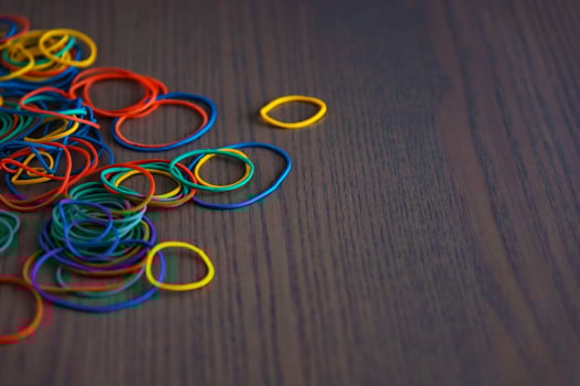 Stationery on the desk in the office. Multicolored rubber bands for papers and money. Space for copying. photo