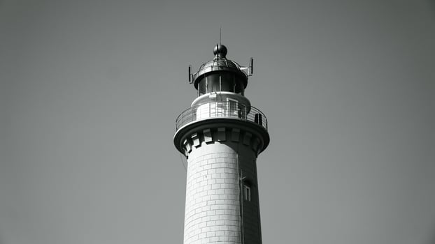 The lighthouse is in black and white photo