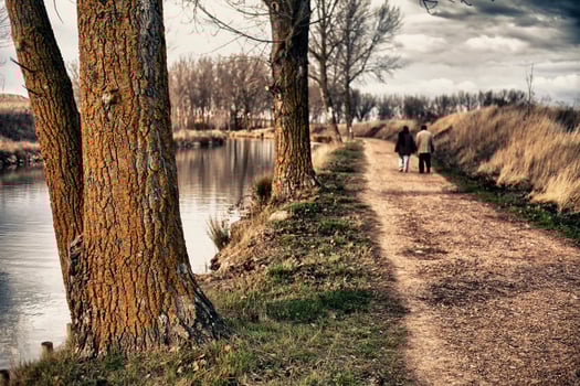 A couple walking by the riverside in autumn in HDR photo technique