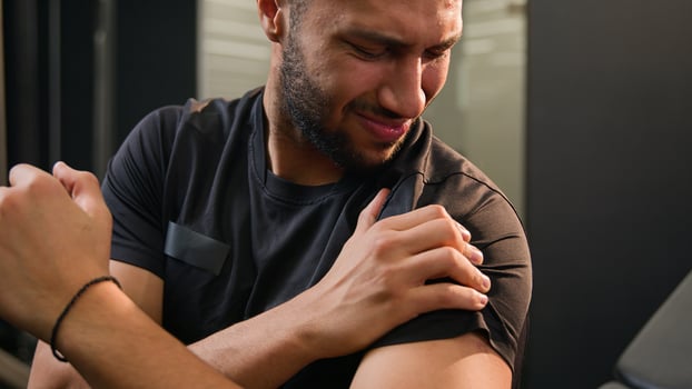 African American multiethnic sad upset tired sporty man feel shoulder ache pain painful hand injury during exercise in sport club gym sportsman athlete male bodybuilder hurt arm problem after workout photo