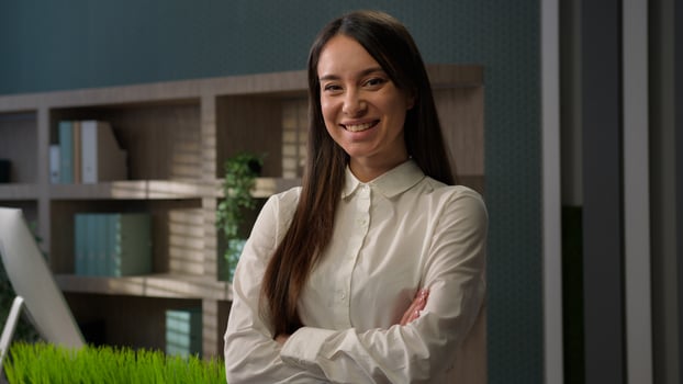 Female business portrait confident Caucasian businesswoman posing in office with hands crossed Caucasian girl smiling happy woman smile at workplace lady employer entrepreneur company owner manager photo