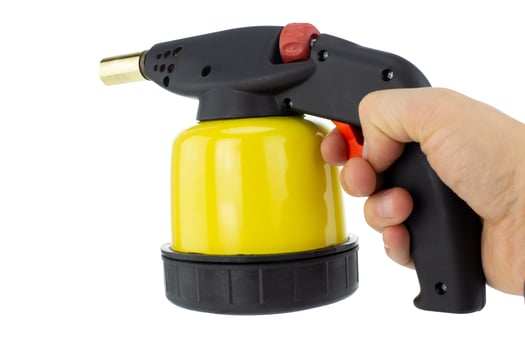 Hand Holding Gas Heat Gun with Yellow Cylinder photo