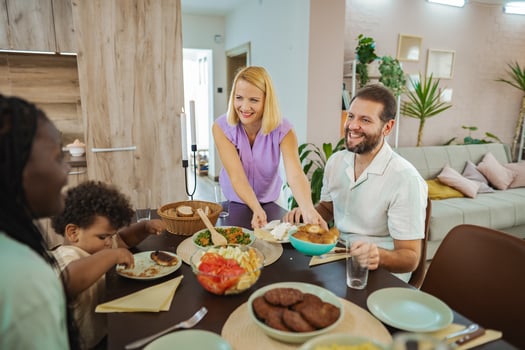 Family gathers joyfully around the dinner table photo