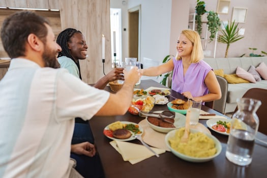 Friends sharing a joyful dinner in a cozy home photo