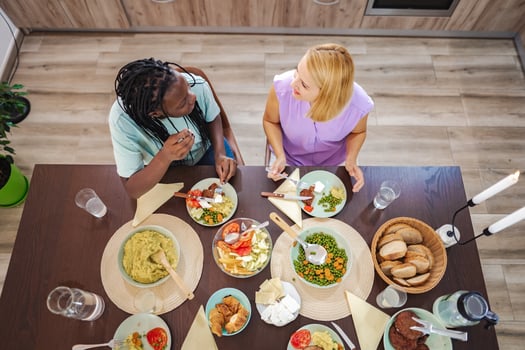 Joyful gathering over vibrant dishes in a cozy dining space photo