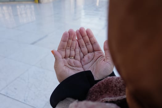 Muslim young woman in hijab is praying in mosque. photo