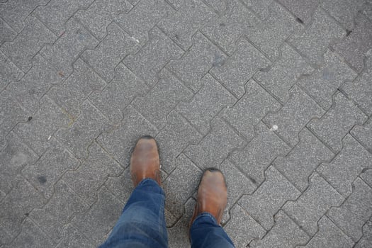Casual Footwear Stylishly Worn on the City Pavement Paired with Trendy Jeans for a Chic Look photo
