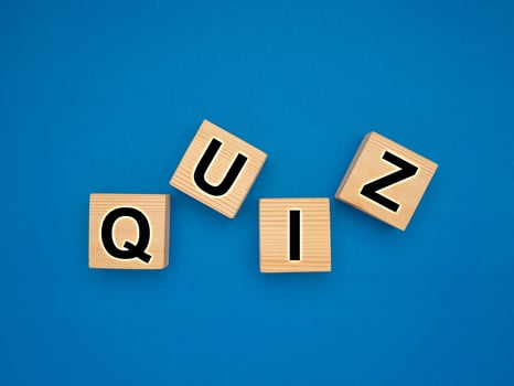 Wooden cubes with the letters QUIZ on a blue background photo