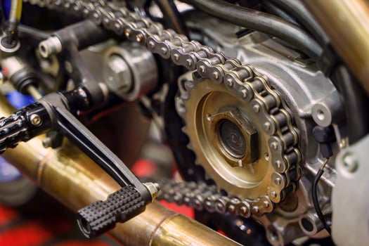 Closeup and crop motorcycle engine drive system with chains and sprockets photo