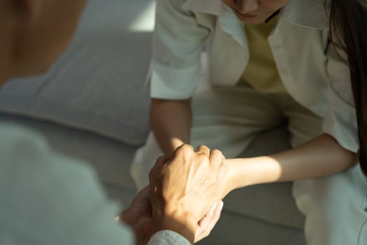 psychiatrist hold hand support each while discussing family issues. doctor encourages and empathy woman suffers depression. psychological, save divorce, Hand in hand together, trust, care photo