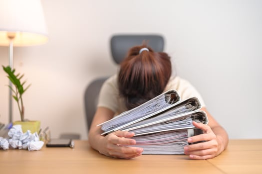 Stressed Asian woman having Tired and Sleepy while working, female businesswoman having headache at office, Exhausted woman with documents folder stack at home late night. Overworked and Overtime photo