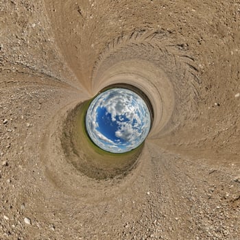 blue hole sphere or globe little planet inside green dry grass or stone with sand frame background photo
