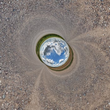 blue hole sphere or globe little planet inside green dry grass or stone with sand frame background photo