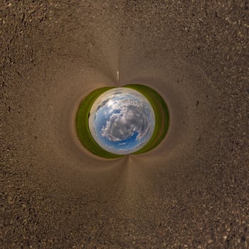 blue hole sphere or globe little planet inside green dry grass or stone with sand frame background photo