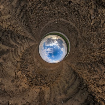 blue hole sphere or globe little planet inside green dry grass or stone with sand frame background photo
