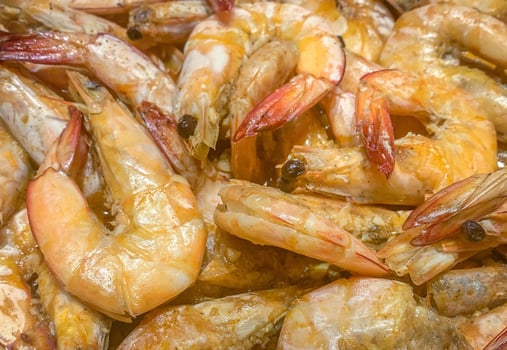Closeup of orange cooked shrimps background from top angle photo