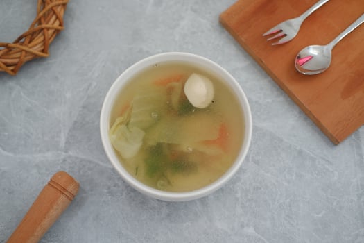 A bowl of soup on a marble table photo