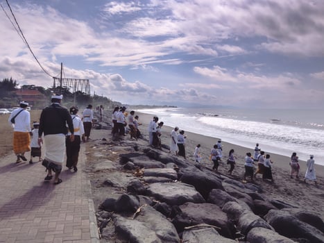 Bali - July 30, 2024. Ngulapin on the beach in the morning is performed by Hindu devotees in Bali as a ceremony to purify or welcome ancestral spirits before other major ceremonies photo