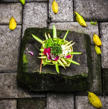 Balinese Hindu offerings, called Canang, are intricate arrangements of flowers, rice, and other symbolic items presented in woven palm leaf trays photo