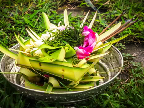 Balinese Hindu offerings, called sesajen, are intricate arrangements of flowers, rice, and other symbolic items presented in woven palm leaf trays photo