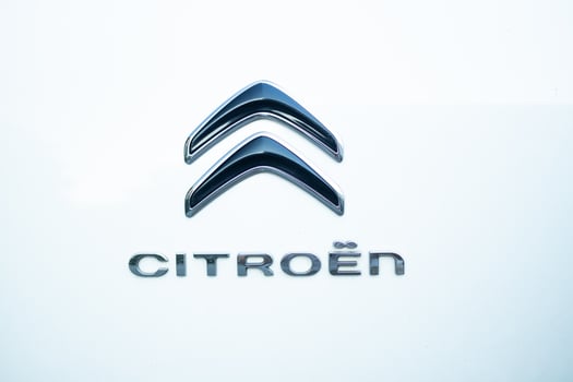 Krakow, Poland - September 2024. Close-up of modern Citroen badge on white car with chrome details photo