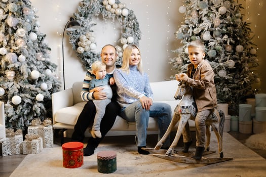 Family enjoys christmas morning, opening presents and laughing together photo