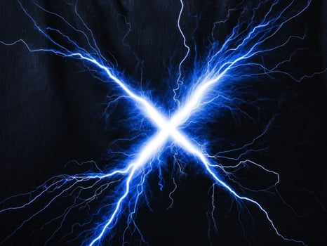 Electric thunder spark light forming letter X on black background. photo