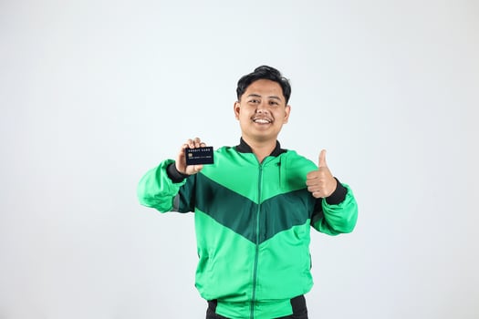 Asian Online Driver Holding Black Credit Card with Ok Gesture photo