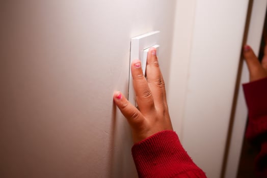 child finger turning on lighting switch with copyspace photo