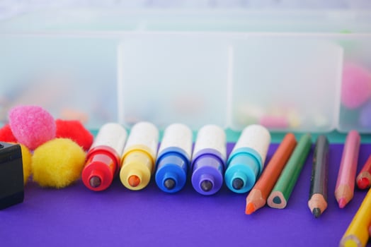 Vibrant and Colorful Art Supplies Perfectly Arranged on a Purple Background for Creative Projects photo