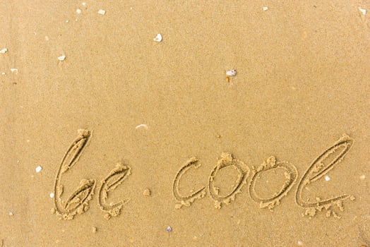 Be cool written on the beach sand photo
