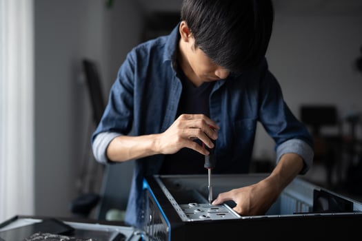a Engineer installing Hardware man is working on a computer in a room photo
