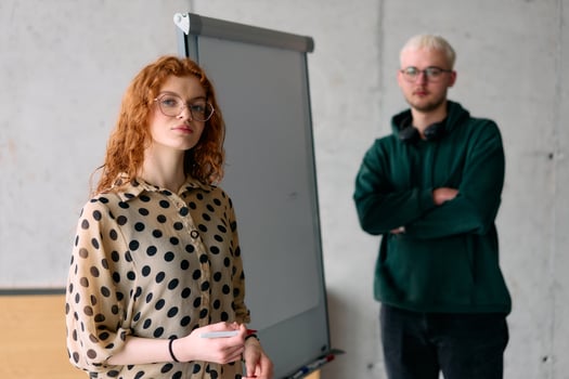 A business colleague collaboratively presenting business goals and strategies to their team in a professional office setting photo