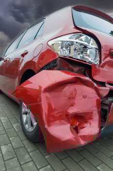 Dramatic View of Damaged Red Car After Accident photo