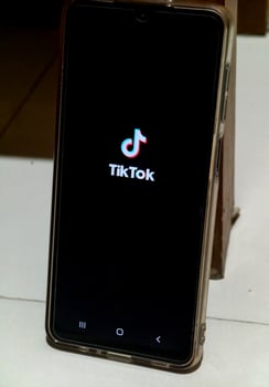 Semarang, November 28 2024. Logo of TikTok brand in Smartphone. A very famous social media. photo
