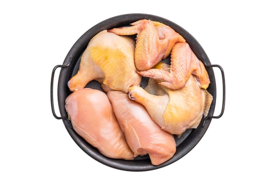 Raw chicken pieces in a black tray, ready for cooking,isolated on white background photo
