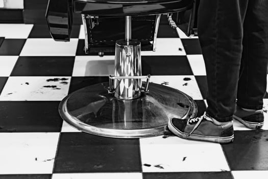 Barbershop floor activity with stylist preparing for haircut service photo