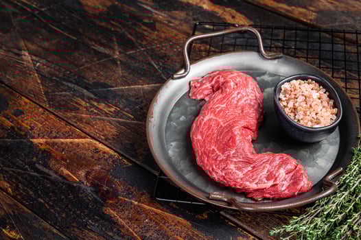 Raw uncooked Machete beef meat steak, skirt steak. Wooden background. Top view. Copy space photo