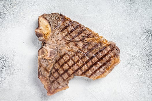 Grilled T-bone or Porterhouse beef meat Steak. White background. Top view. Copy space photo