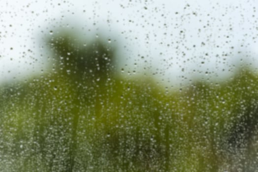 Rain water drops on a window glass defocused photo