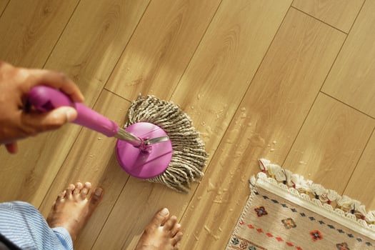 Effectively Cleaning the Floor Using a Bright and Stylish Pink Mop photo