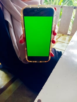 Woman Holding Smartphone Green Screen photo
