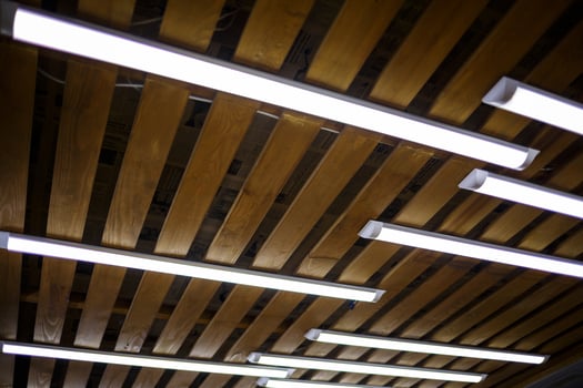 Wooden ceiling with long white lamps photo
