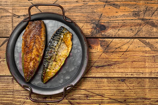 Baked Grilled mackerel fillets. Wooden background. Top view. Copy space photo