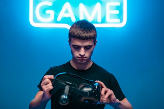 Young man holding VR glasses. Strat games. photo