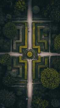 Hedge mazes spread through gardens beside palace grounds in France , wallpaper photo