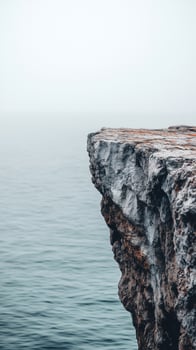 Cliff face dropping straight down to water below , photorealistic photo