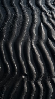Waves break on shore creating patterns in sand, wallpaper photo