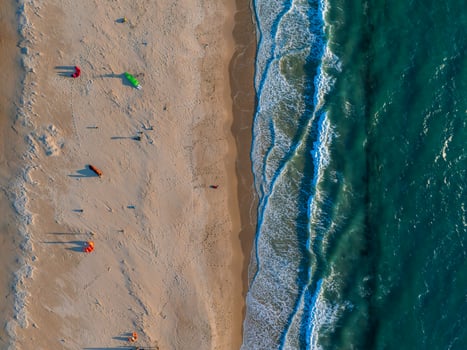 Aerial View of Tarifa Beach with Colorful Kites and Turquoise Ocean photo