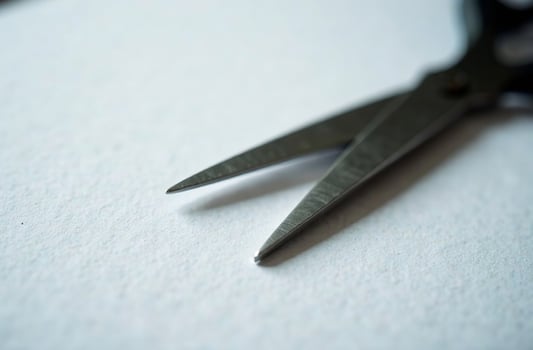 Scissors on white paper, workplace in office, student desk photo